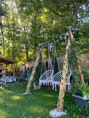 a swing set in a yard with a tree at Villa Janet in Dolna Banya
