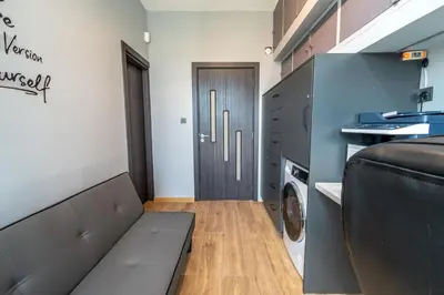a living room with a couch and a washer and dryer at Vitoshka's Finest in Sofia