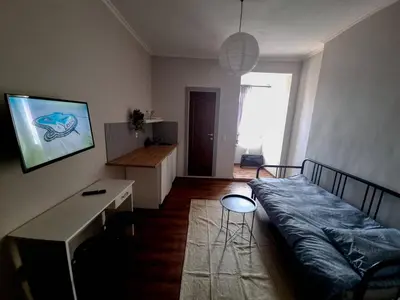 a room with a bed and a desk in it at Welcoming Studio in Sofia Center in Sofia