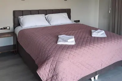 a large bed with two towels on top of it at Zora in Blagoevgrad