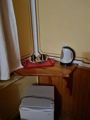 a desk with a red item on it next to a window at Астра къща за гости in Koprivshtitsa