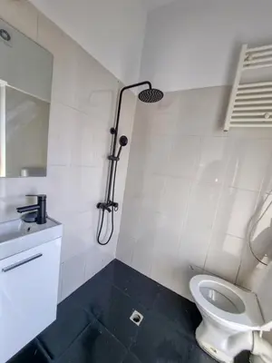 a white bathroom with a shower and a toilet at Inviting Studio in Sofia Center in Sofia