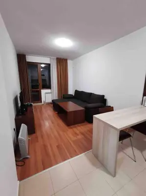 a living room with a couch and a table at Lovely private apartment in Belelvedre in Bansko