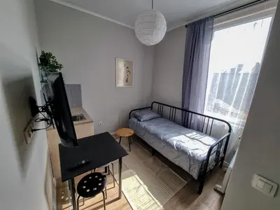 a small room with a bed and a window at Sunny Studio in Sofia Center in Sofia