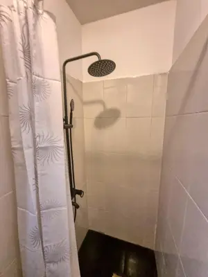 a shower with a shower curtain in a bathroom at Sunny Studio in Sofia Center in Sofia