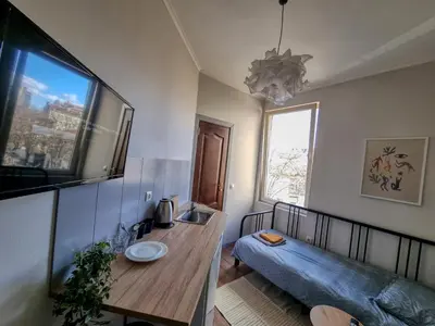 a living room with a couch and a table at Relaxing Studio in Sofia Center in Sofia