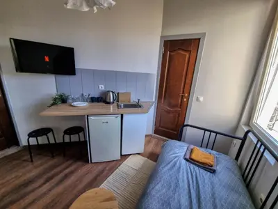 a small room with a kitchen and a bed at Relaxing Studio in Sofia Center in Sofia