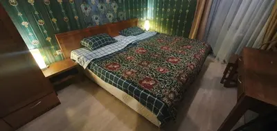 a bedroom with a bed with a green wall at Harriet Hill Designer Bansko in Bansko