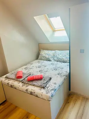 a small bedroom with a bed with a window at Joy Station Appartment 2 in Sofia