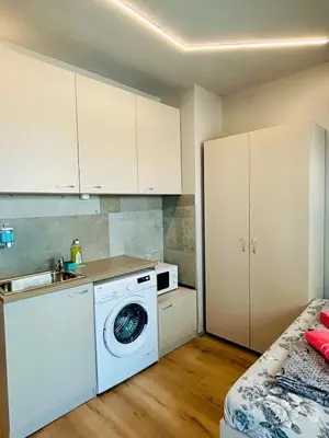 a kitchen with a washing machine and a sink at Joy Station Appartment 2 in Sofia