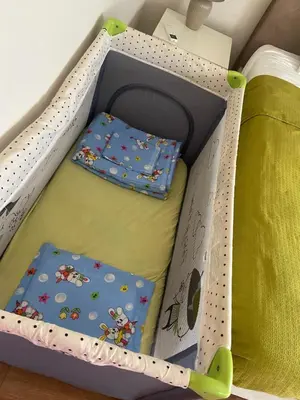 a toy box with two pillows in it at M&M Center Apartment with free parking in Plovdiv