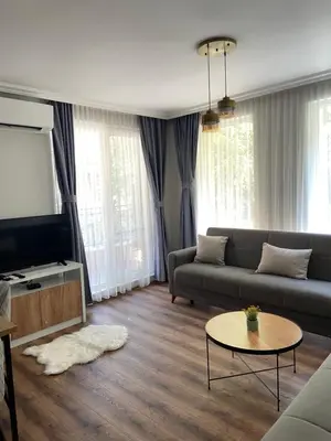 a living room with a couch and a flat screen tv at M&M Center Apartment with free parking in Plovdiv