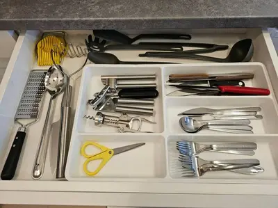 a white tray filled with utensils in a drawer at Bansko Private VIP Apartment in Bansko