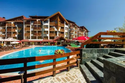 a hotel with a swimming pool and a resort at Bansko Private VIP Apartment in Bansko