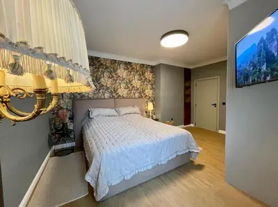a bedroom with a bed and a flat screen tv at Luxury 2 Bedroom Top Central Apartment in Sofia