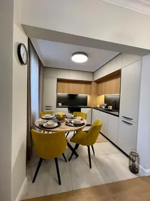 a kitchen with a table and yellow chairs in a room at Luxury 2 Bedroom Top Central Apartment in Sofia