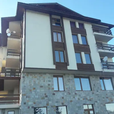 a tall building with windows on the side of it at Rositsa 28 in Pamporovo