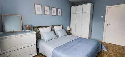 a bedroom with a bed with a mirror and a dresser at 5munutes from the airport & 15 from the City center in Sofia