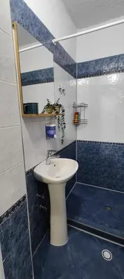 a bathroom with a white sink and a shower at 5munutes from the airport & 15 from the City center in Sofia