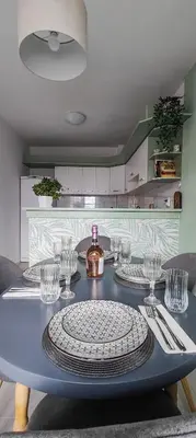 a blue table with two plates and glasses on it at 5munutes from the airport & 15 from the City center in Sofia
