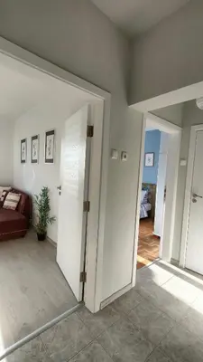 a living room with a door open to a bedroom at 5munutes from the airport & 15 from the City center in Sofia