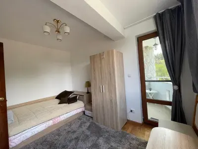 a bedroom with a bed and a large window at Къща за гости Замък Никола in Shtarkelovo Gnezdo