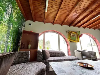 a living room with two couches and a table at Къща за гости Замък Никола in Shtarkelovo Gnezdo