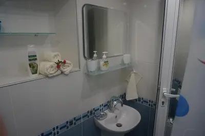 a bathroom with a sink and a mirror at DaRoom in the heart of Plovdiv in Plovdiv