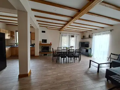 a large living room with a table and chairs at Тиловите къщи in Ribarica