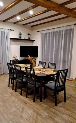 a dining room table and chairs in a room at Тиловите къщи in Ribarica