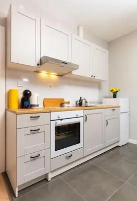a kitchen with white cabinets and a stove top oven at Private House in the Center of Plovdiv in Plovdiv