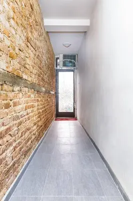 a hallway with a brick wall and a door at Private House in the Center of Plovdiv in Plovdiv