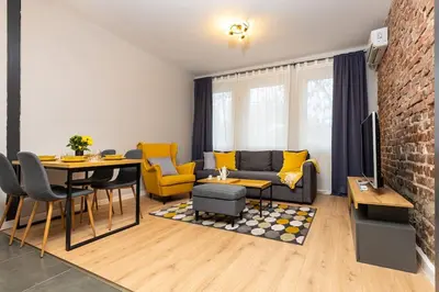 a living room with a couch and a table at Private House in the Center of Plovdiv in Plovdiv