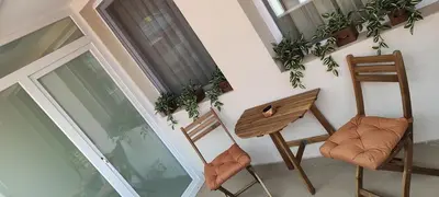 an apartment balcony with two chairs and a table at Kiki Home in Blagoevgrad