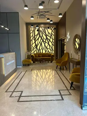 a lobby with yellow chairs and a large window at City Park Inn - Art Gallery in Plovdiv