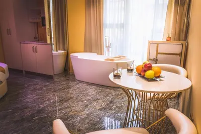 a bathroom with a tub and a table with fruit on it at Hidden Bank: Pearls in Plovdiv