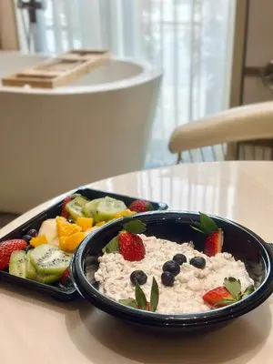 a bowl of oatmeal and fruit on a table at Hidden Bank: Pearls in Plovdiv