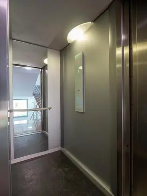 a hallway with a glass door and a window at Modern Apartment 3 with Parking next to Bulgaria Mall in Sofia