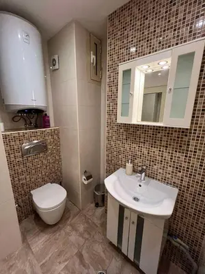a bathroom with a sink and a toilet at Rio Sunny 2BDR Apt near NDK - Metro - non-stop paid public Parking in Sofia