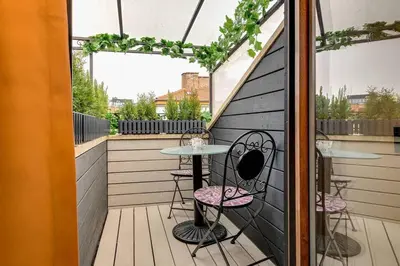 a patio with a table and chairs on a balcony at Top 5 - Loft - Top Location - Designer Interior in Sofia