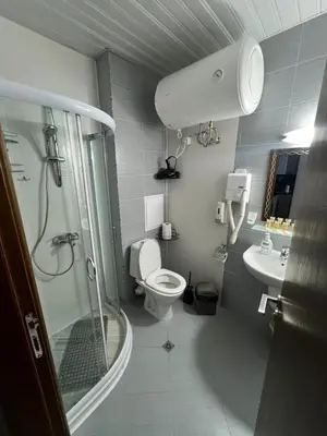 a bathroom with a shower and a toilet and a sink at VIP Apartment Belvedere Club in Bansko