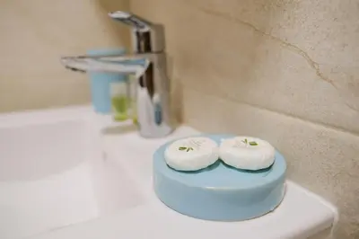 two rolls of toilet paper sitting on a bathroom sink at Apartment in the city center in Plovdiv